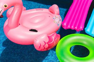 pink inflatable flamingo and green inflatable ring