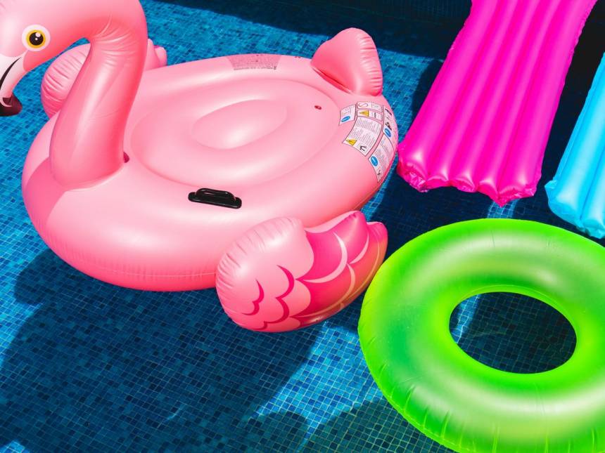 pink inflatable flamingo and green inflatable ring