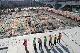 seven construction workers standing on white field