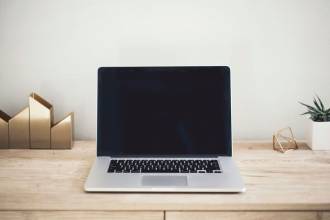 MacBook Pro on top of brown table