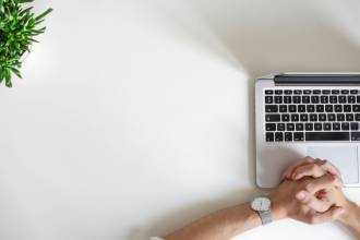 person wearing watch near laptop