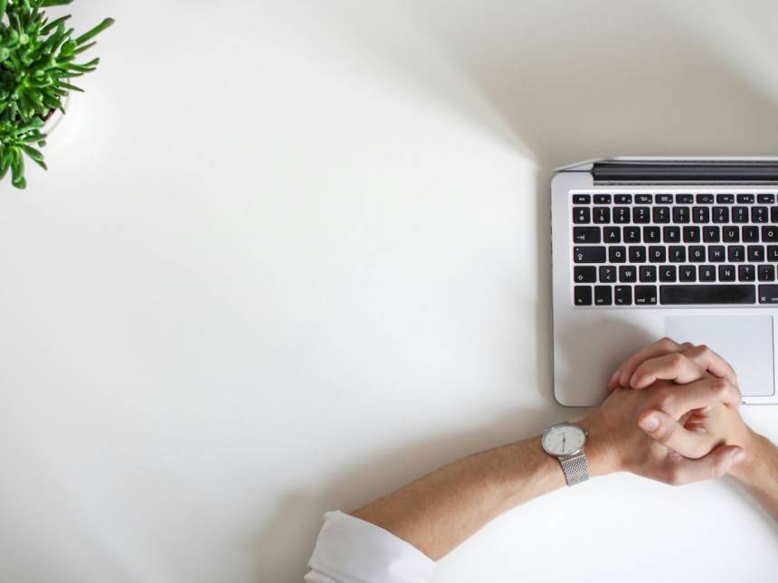 person wearing watch near laptop