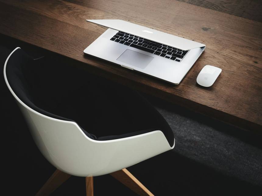 Apple MacBook beside computer mouse on table