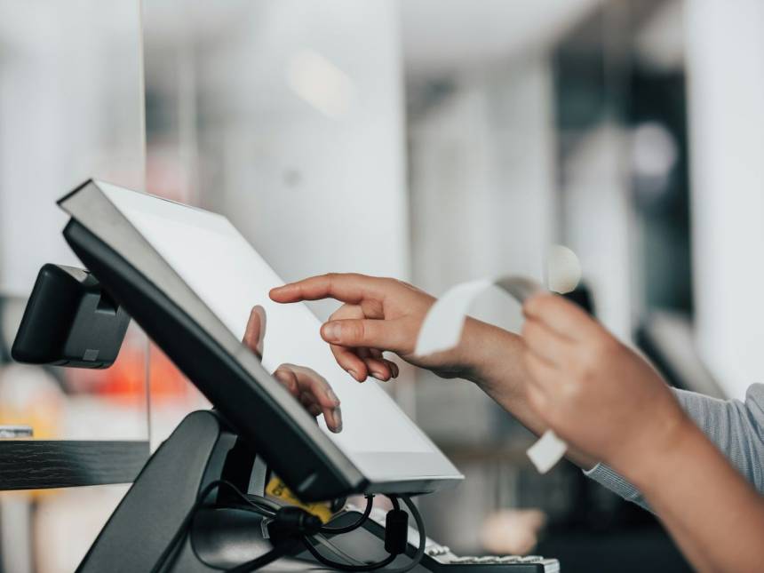 a person is using a pos machine in a store