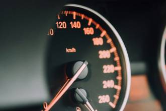 closeup photo of black analog speedometer