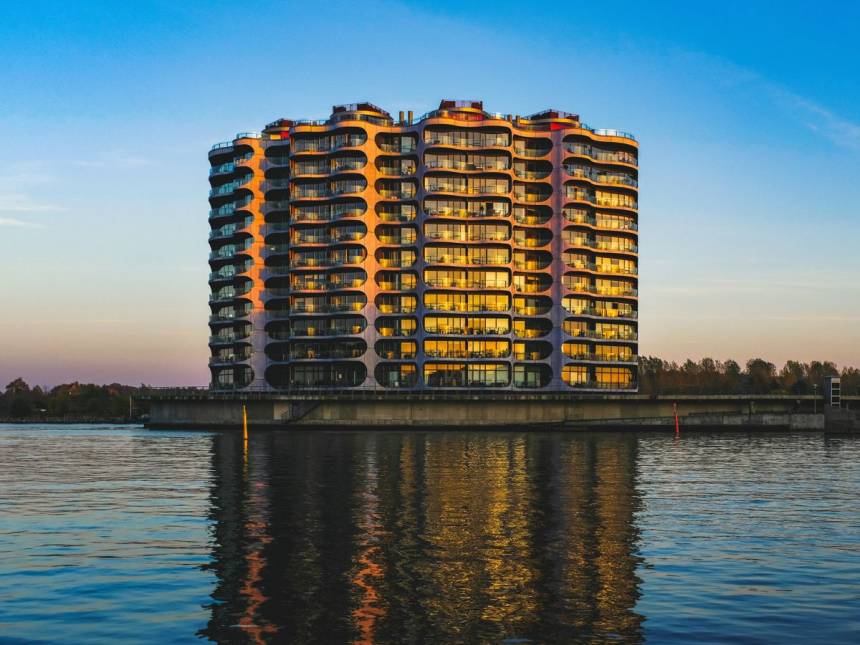 brown and white high rise building near body of water during daytime