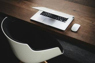 Apple MacBook beside computer mouse on table