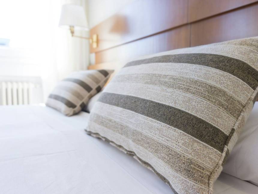 gray and black throw pillow on bed