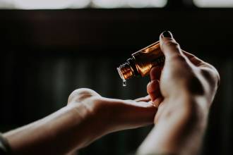 person holding amber glass bottle